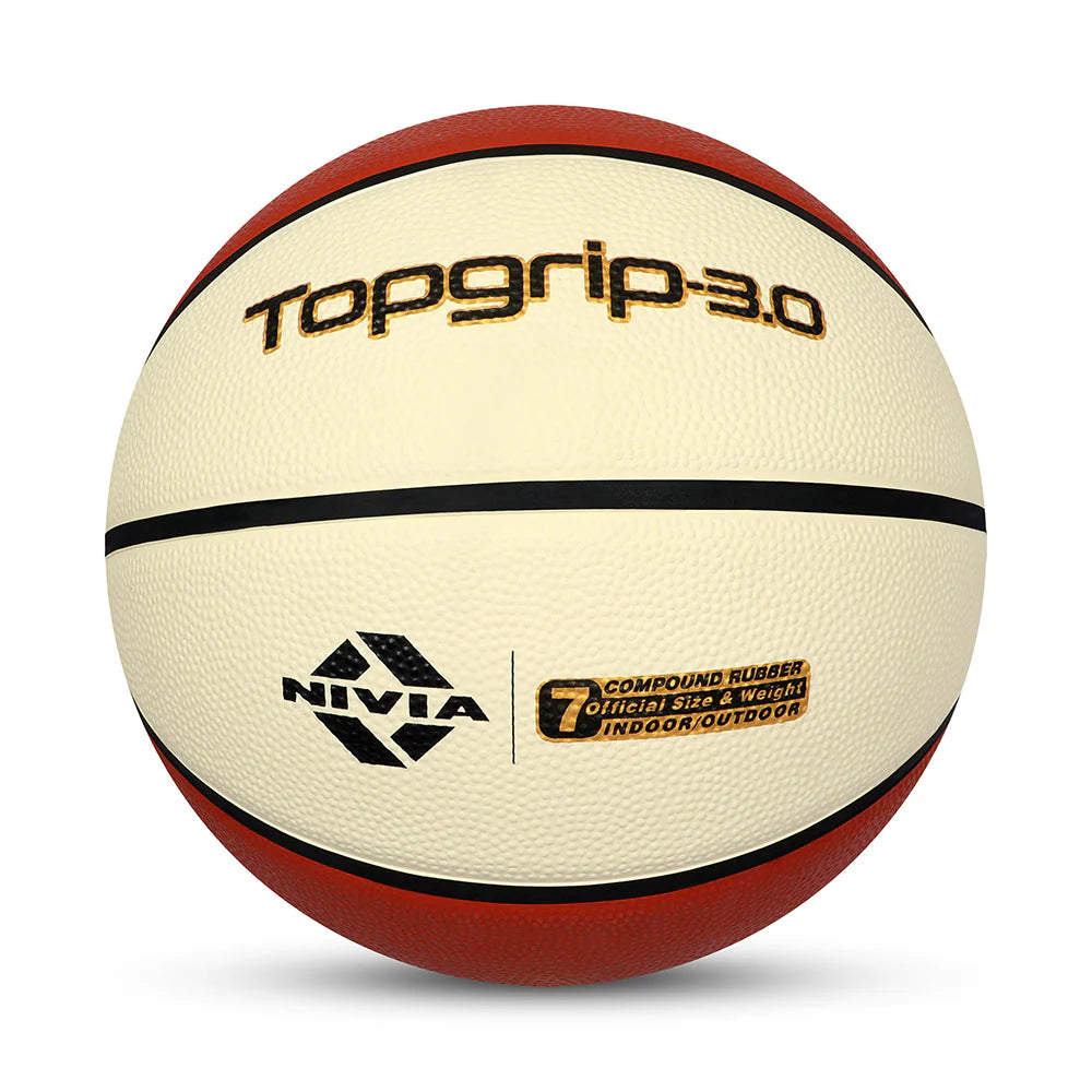 Close-up of the NIVIA Top Grip 3.0 Basketball match ball with a textured cream and red surface, black channel lines, and printed branding, indicating compound rubber construction with official size and weight for indoor and outdoor play.