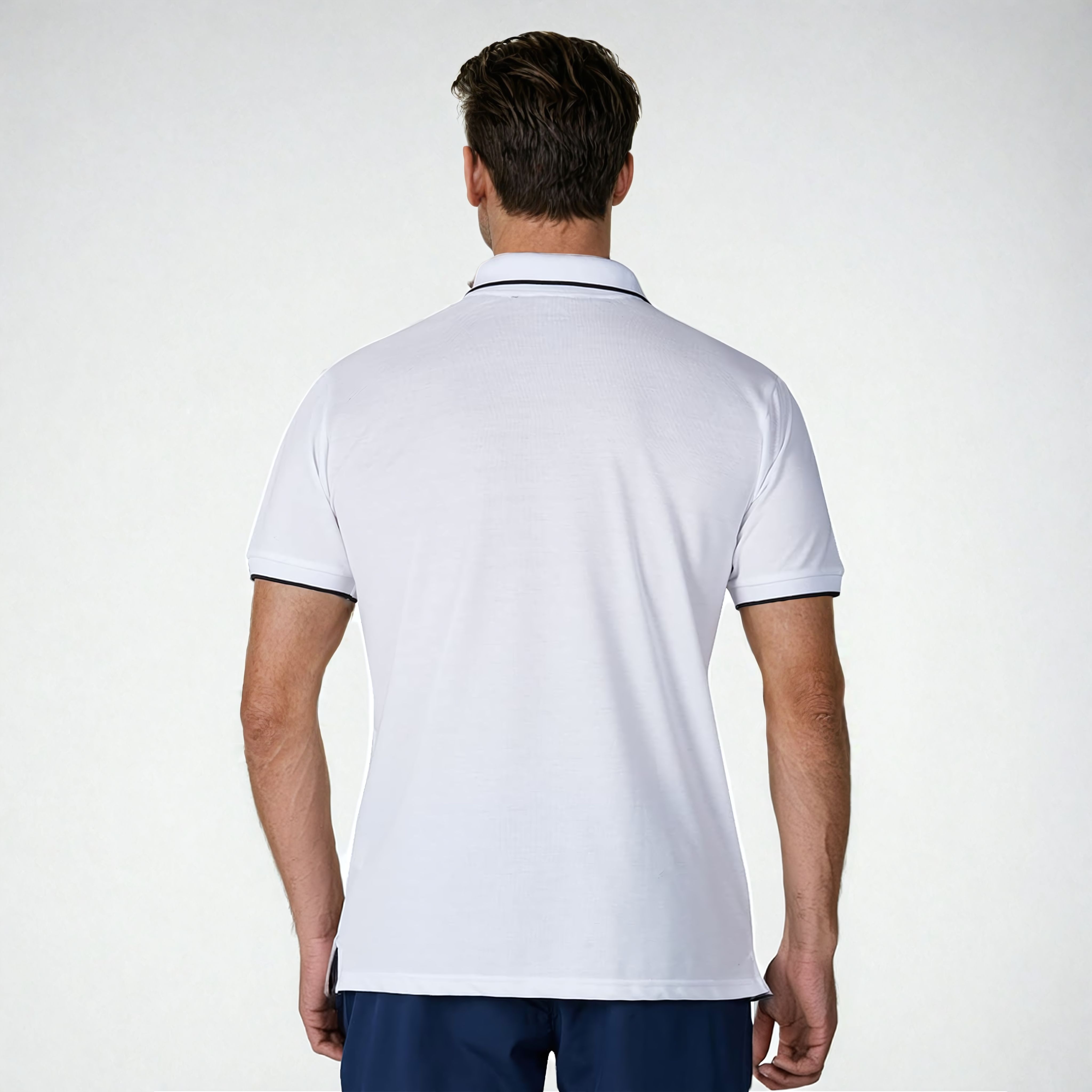 Back view of a model wearing the NIVIA Ray 17 Polo Shirt in light grey, featuring a classic collar with contrast trim and short sleeves, made from polyester cotton fabric for casual and everyday wear.