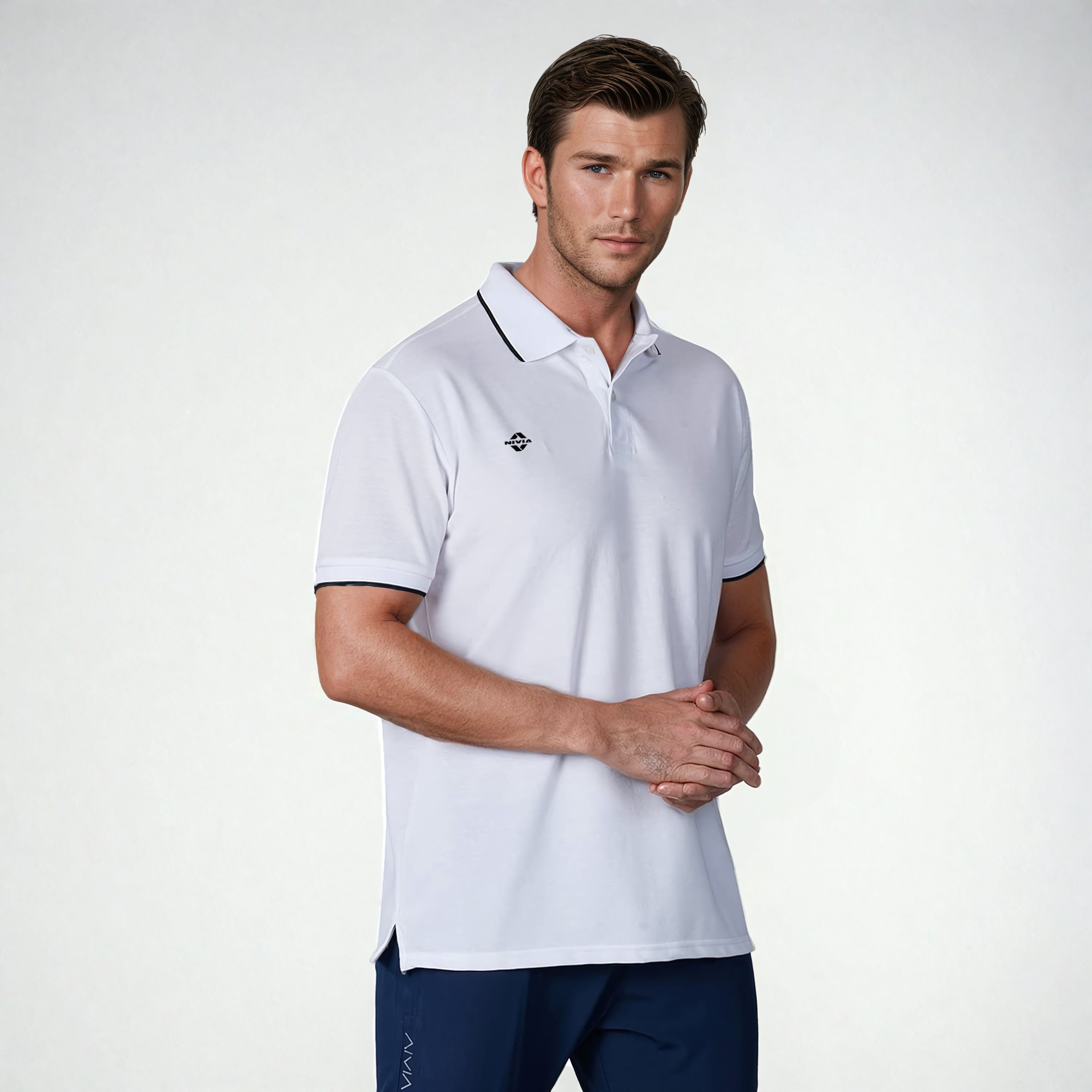 Close-up angled view of a model wearing the NIVIA Ray 17 Polo Shirt in light grey, featuring a classic collar with button placket and contrast trim on the collar and sleeve cuffs, made from polyester cotton fabric for everyday casual wear.