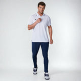Full-length front view of a model wearing the NIVIA Ray 17 Polo Shirt in light grey with a classic collar and contrast trim on the collar and sleeve cuffs, made from polyester cotton fabric for everyday casual wear.