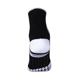 Rear view of a NIVIA Court Sock No Sweat in black with a white heel panel and anti-slip silicone grip dots on the sole, featuring a high ankle design for enhanced support and stability during sports activities.