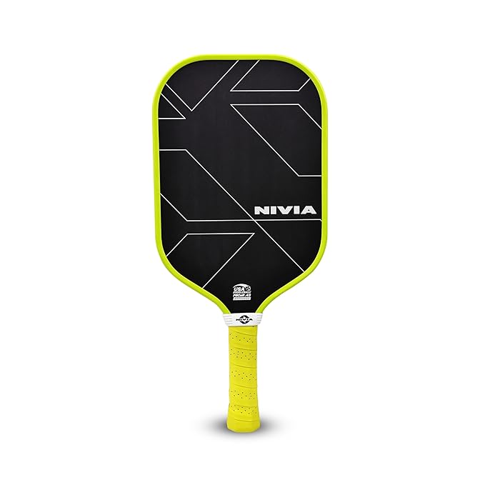 Front view of the NIVIA K-3000 Pro Pickleball Paddle featuring a black carbon surface with geometric line detailing and NIVIA branding, a neon yellow edge guard, and a matching cushioned handle grip. Designed for outdoor pickleball play for kids and adults, the paddle comes in a standard size for controlled gameplay and includes a cover bag for storage and transport.