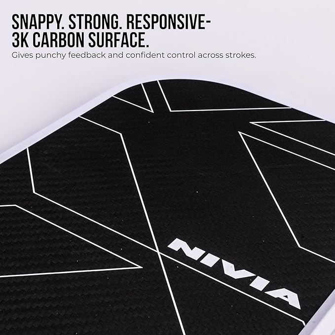 Close-up of Nivia K-2500 Pickleball Paddle showing black 3K carbon surface with white geometric pattern and NIVIA branding.