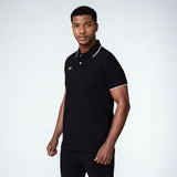 Model wearing the NIVIA Ray 17 Polo Shirt in black, featuring a classic collar with button placket and contrast trim on the collar and sleeve cuffs, made from polyester cotton fabric for everyday casual wear.
