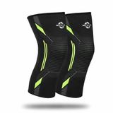 Pair of NIVIA Knitted Knee Support Slip-In sleeves in black with green accents, designed to provide compression and stability for knee support during physical activities.