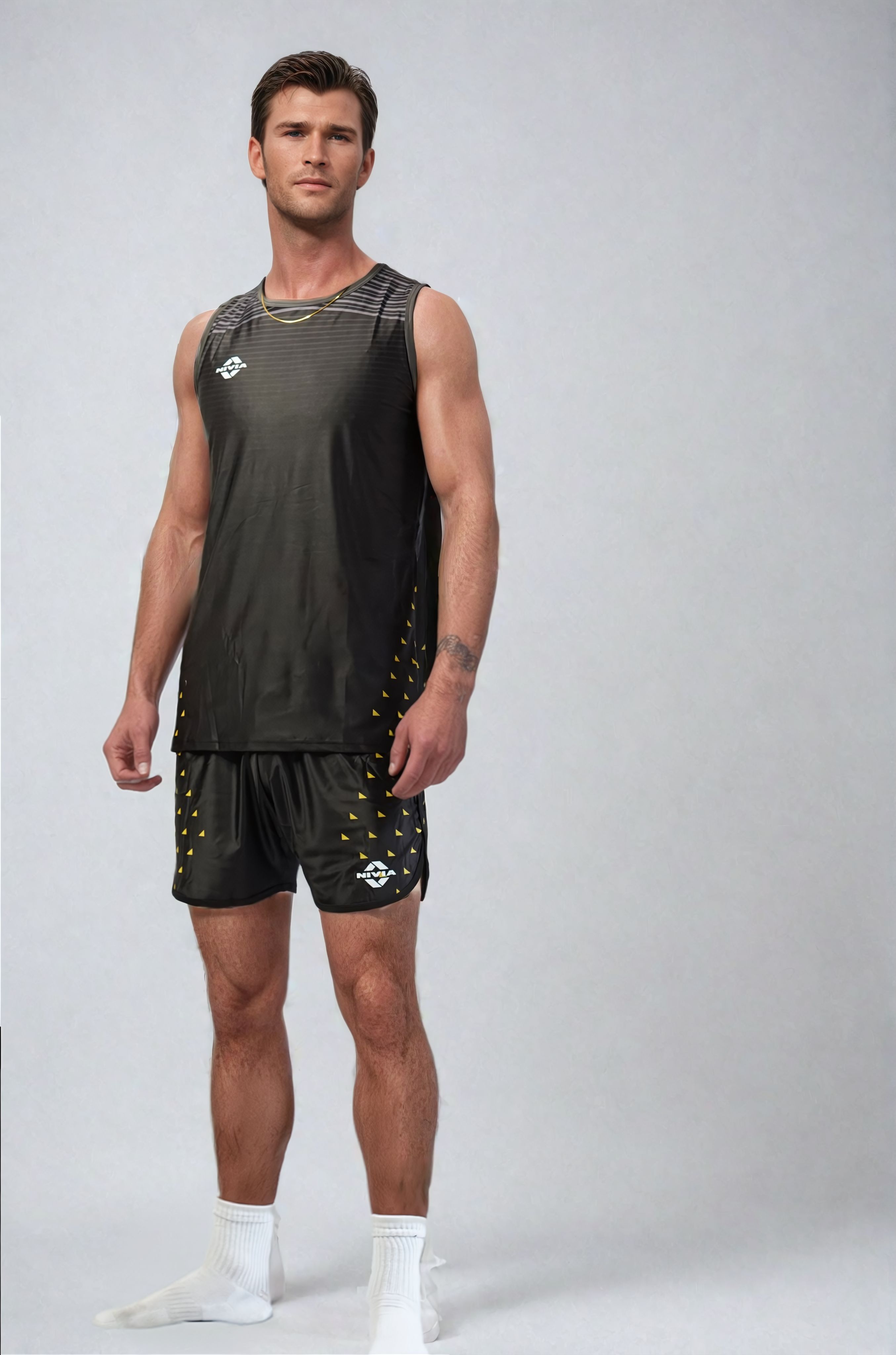 Full-length front view of a model wearing the NIVIA Skylite Track and Field Athletic Kit in black, featuring a sleeveless jersey and matching shorts, designed for track and field training and sports activities.