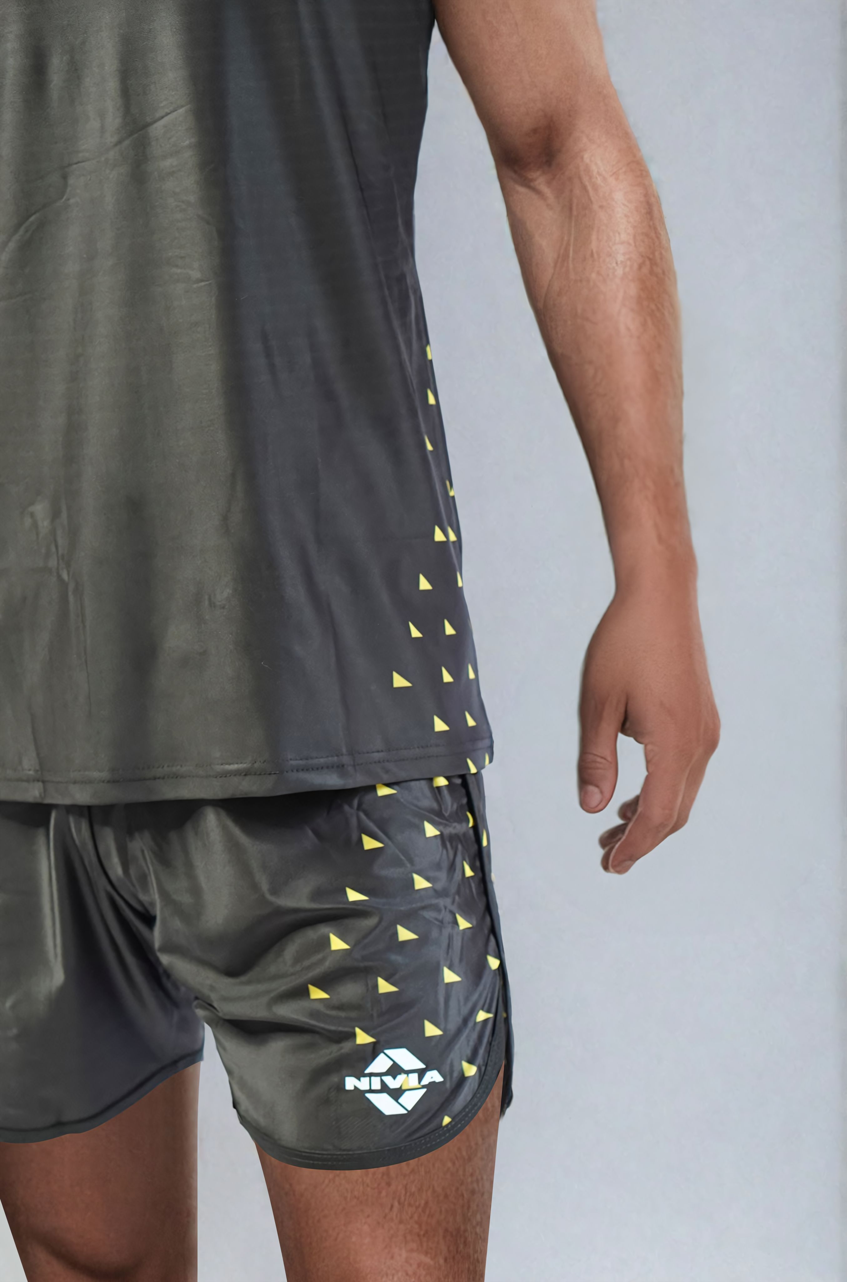 Close-up view of the NIVIA Skylite Track and Field Athletic Kit in black, highlighting the sleeveless jersey and matching shorts with yellow accent detailing, designed for track and field training and sports activities.