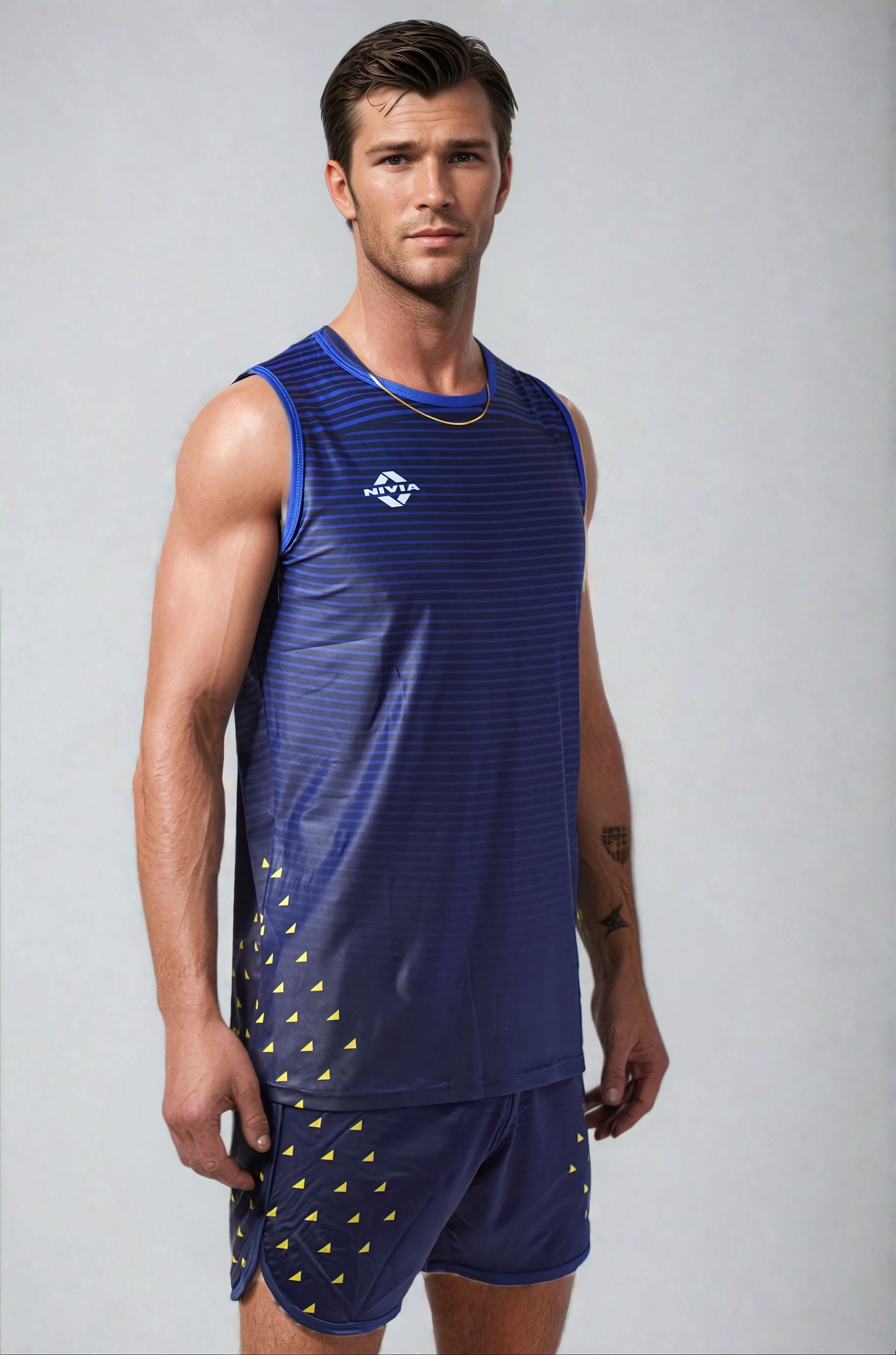 Model wearing the NIVIA Skylite Track and Field Athletic Kit in blue, featuring a sleeveless jersey and matching shorts with yellow accent detailing, suitable for track and field training and sports activities.