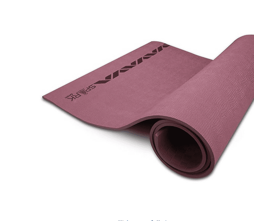 NIVIA Spark EVA Yoga Mat in a wine color, partially rolled to show its dual-textured surface for enhanced grip and stability. Made from EVA and LDPE foam, the lightweight exercise mat is designed for yoga and home or gym workouts.