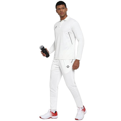 Male model wearing white NIVIA Crick 1000 cricket pants with a dotted jacquard design, paired with a matching white sports top and white-red athletic shoes, showcasing the breathable and performance-focused fit for on-field play.
