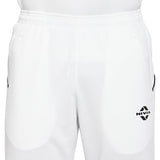 Close-up view of white NIVIA athletic track pants featuring breathable textured fabric, elastic waistband, side pockets, and a black NIVIA logo printed on the upper thigh.