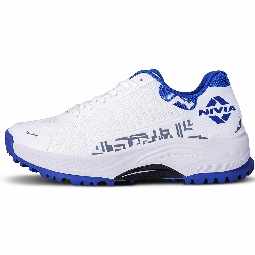 NIVIA Crick 1000 Cricket Shoes in white and blue with breathable mesh upper, TPU Fusion Technology support, reinforced toe area, cushioned midsole, and rubber outsole designed for grip during cricket matches and training sessions.