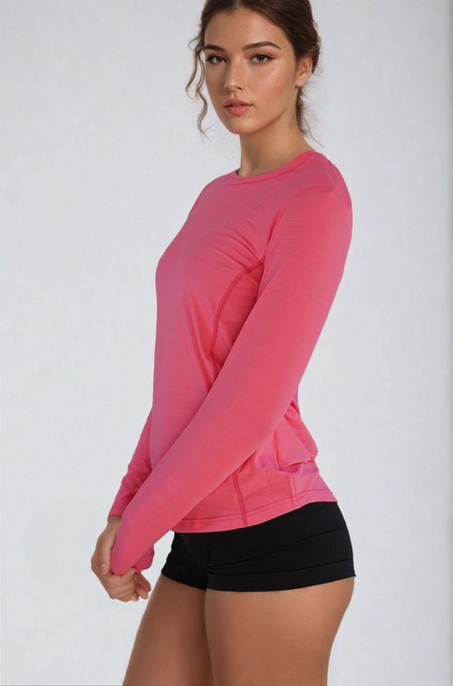 Woman wearing the NIVIA Nitro 6 Full Sleeve T-Shirt in pink, featuring a round neck and fitted design, suitable for fitness activities and casual wear with a blend of style and comfort.