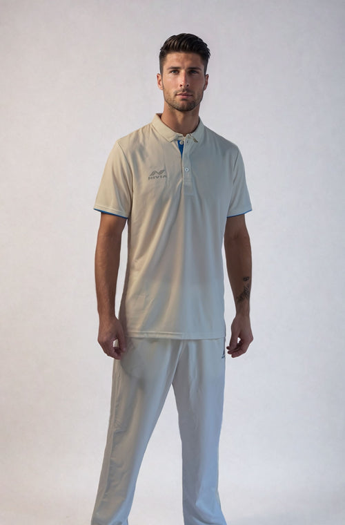 Full-length front view of a model wearing the NIVIA Hook Cricket Set in light beige, featuring a short-sleeve cricket jersey with collar and matching trousers, suitable for cricket training sessions and matches.